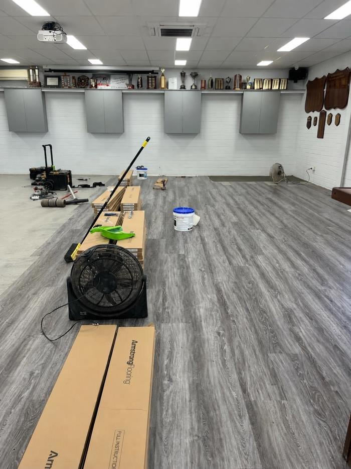 Vinyl plank flooring installation underway