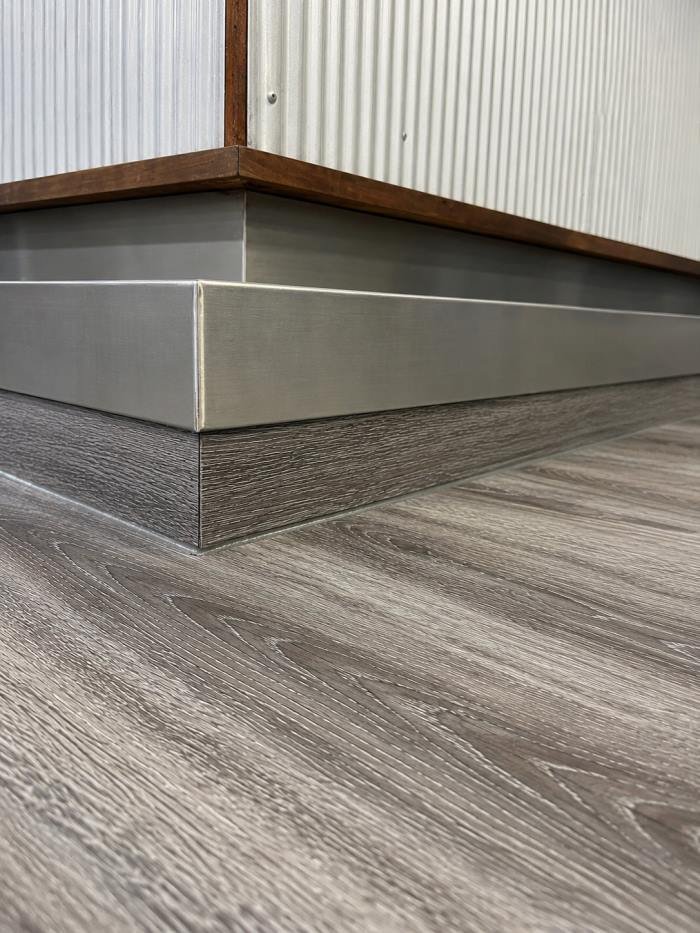 Close-up of the finished flooring edge and trim detail